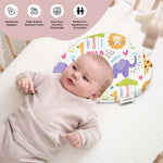 ADMIRAE Head shaping heart Baby Pillow with colorful animal prints supporting a newborn lying on a white textured mattress