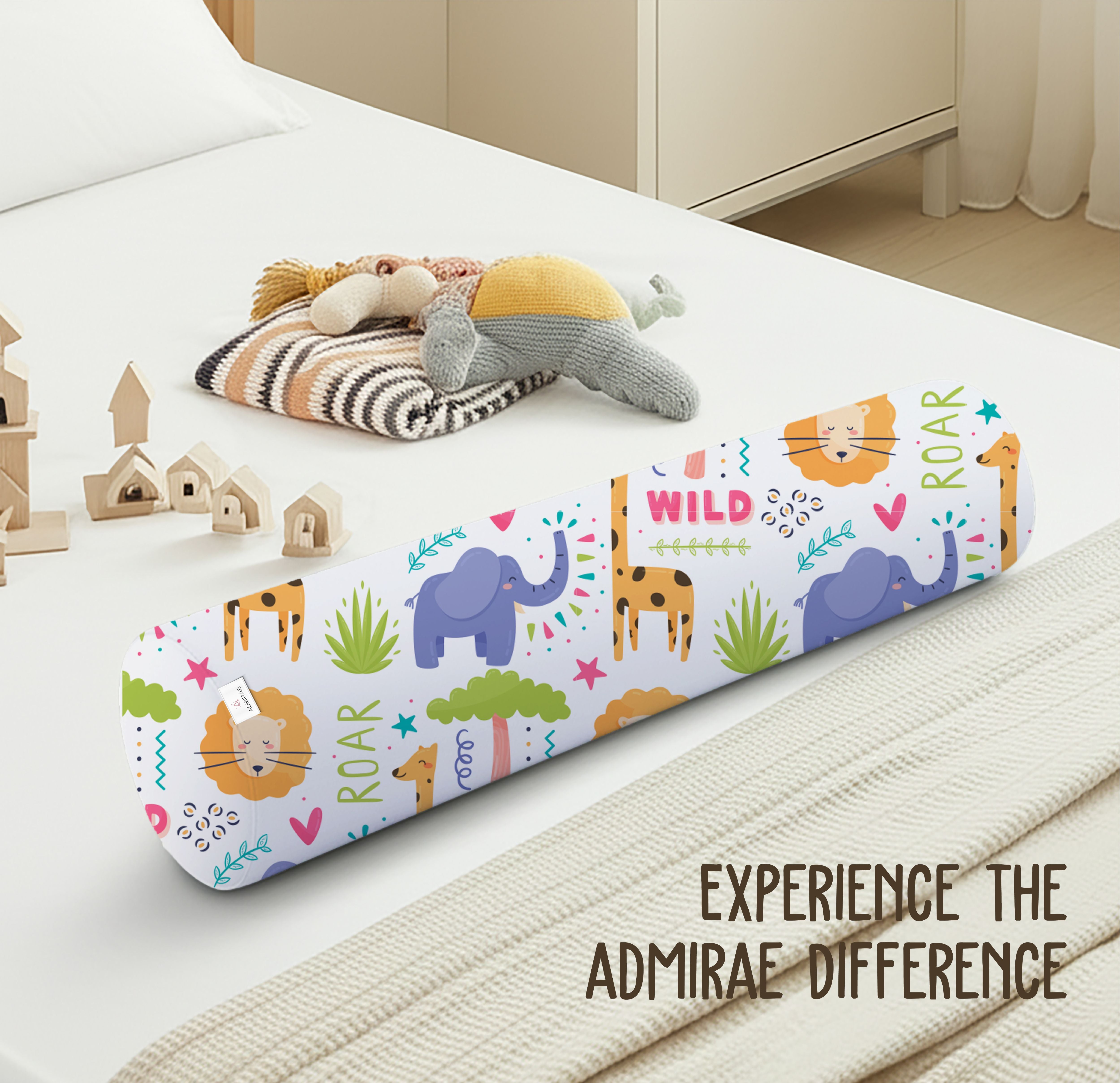 ADMIRAE baby bolster pillow with colorful wild animal prints including elephants, lions, and giraffes on a white bed