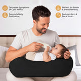 ADMIRAE black baby feeding pillow supporting a baby during bottle feeding to reduce arm and back strain