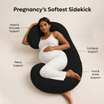 Pregnant woman using ADMIRAE black C shape pregnancy pillow providing head shoulder pelvic and full body support