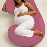 Pregnant woman lying comfortably with ADMIRAE C shape pregnancy pillow in pink for full body support