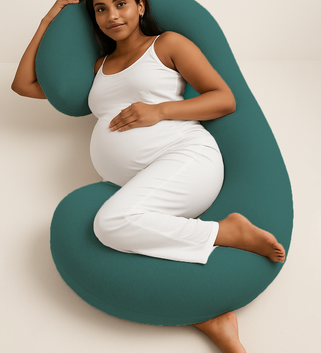 Pregnant woman comfortably lying with ADMIRAE green pregnancy pillow supporting her back and belly
