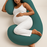 Pregnant woman comfortably lying with ADMIRAE green pregnancy pillow supporting her back and belly