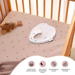 ADMIRAE heart shape baby pillow with gentle head and neck support in a wooden crib