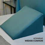 ADMIRAE memory foam wedge cushion in teal on a bed for back support and comfort