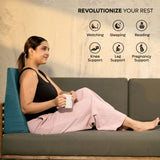 Woman sitting comfortably on sofa using ADMIRAE memory foam wedge cushion for back support