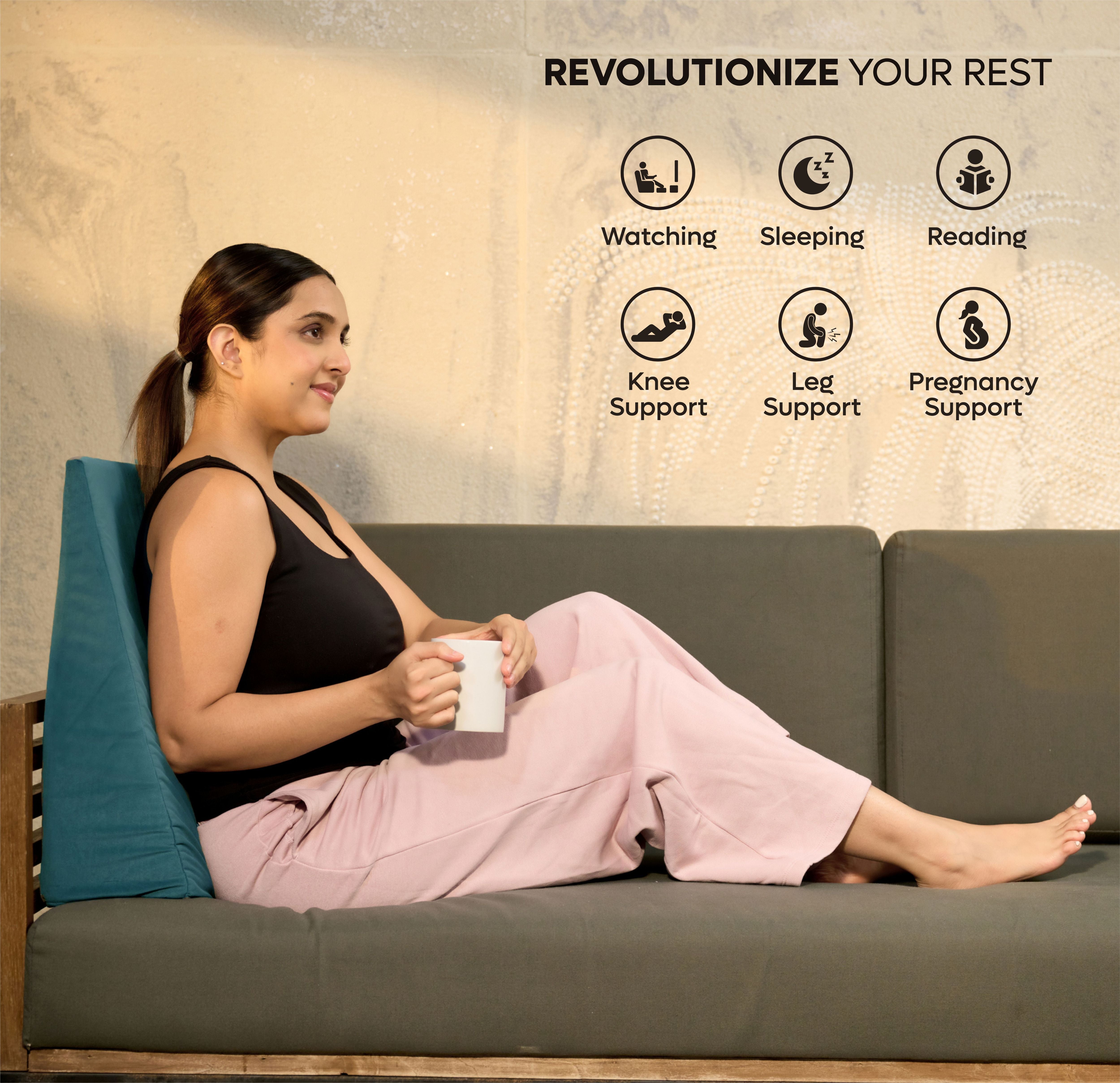 Woman sitting comfortably on sofa using ADMIRAE memory foam wedge cushion for back support