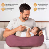 Dad using ADMIRAE Feeding Pillow to bottle feed baby while reducing arm and back strain