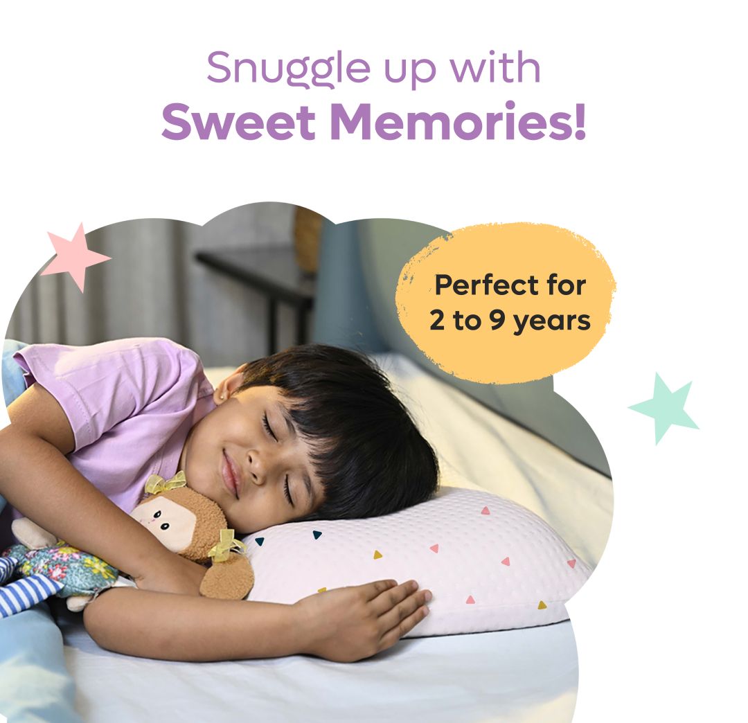 Child peacefully sleeping on a pink memory foam toddler pillow with colorful triangle patterns