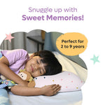 Child peacefully sleeping on a pink memory foam toddler pillow with colorful triangle patterns
